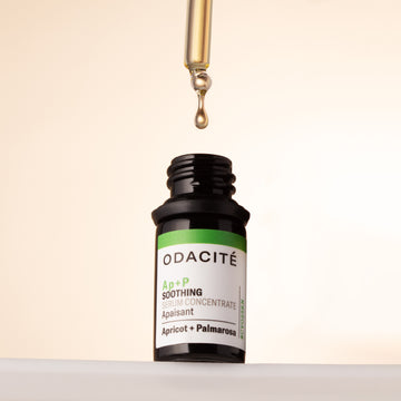 A dropper releases Odacite Soothing Apricot + Palmarosa Ap+P Serum for sensitive skin, shown against a light background.