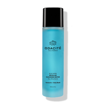 Blue bottle of Odacité Blue Aura Turmeric + Holy Basil Micellar Cleansing Water with black cap and labeled front.