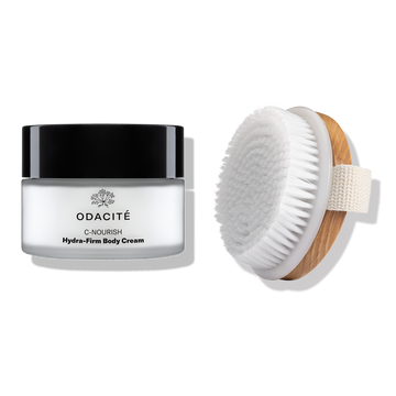 Odacité’s The Body Ritual next to a wooden-handled dry brush with white bristles.