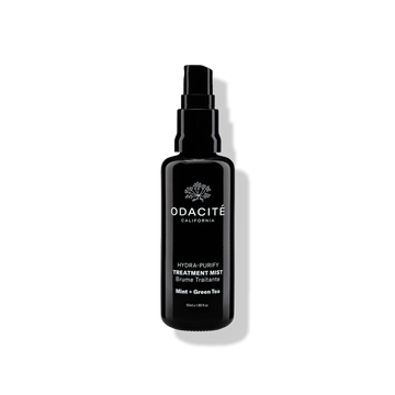 Odacité Hydra-Purify Treatment Mist sample spray bottle casting a soft shadow on a plain light background.