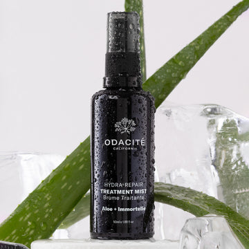 Odacite Hydra-Repair Aloe + Immortelle Treatment Mist in a clear spray bottle designed for mature skin.