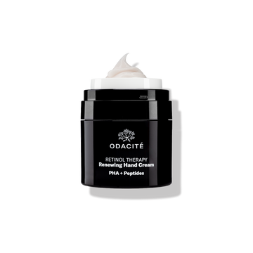 Odacité Retinol Therapy Renewing Hand Cream with PHA + Peptides in a matte black jar with white text.