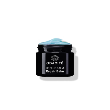 Odacite le Blue Balm Black jar labeled Blue Chamomile + Shea Butter Repair Balm for dry skin on a white background.