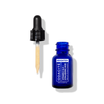 Odacité Brightening Serum Vitamin C & E + Hyaluronic Acid in a clear bottle with yellow dropper shown upright.