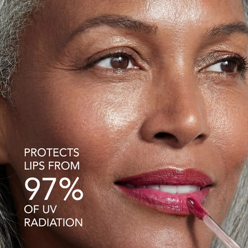 Woman applies Odacité SPF 40 Nourishing Lip Serum Trio in pink; tube visible, serum coats her lips.