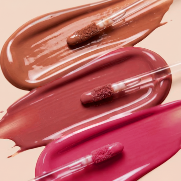 Three Odacité SPF 40 Nourishing Lip Serum tubes with brown, mauve, and pink swatches on a light background.