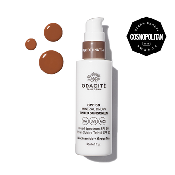 Odacité SPF 50 Tinted Mineral Drops bottle with niacinamide, green tea, and a Cosmopolitan Clean Beauty Award label visible.