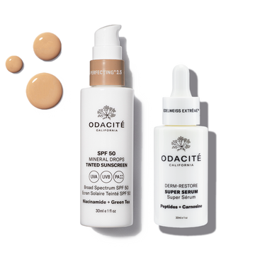 Two skincare products from Odacite on a white background with sunscreen drops.