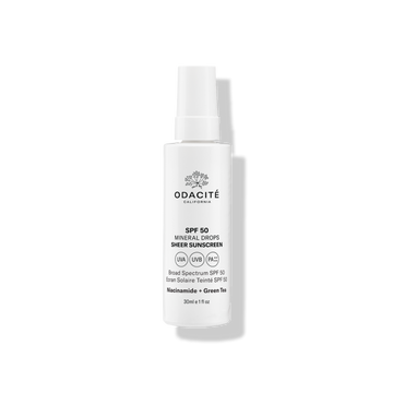 Odacité Mineral Drops SPF 50 Sheer Sunscreen with Niacinamide & Green Tea in a white bottle, labeled broad spectrum.