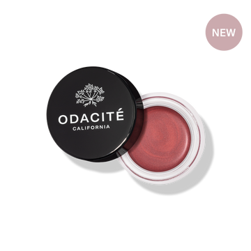 Odacité SPF 50 Color Balm Duo in deep rosy shade, shown open in a jar. Creamy texture and compact packaging are visible.