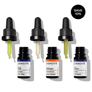 Odacité Skin Glow Serum Set with three glass dropper bottles, each containing a different colored serum.