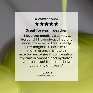 A person admires Odacité’s Age-Defying Fundamentals with a stream of glowing green liquid in the background.