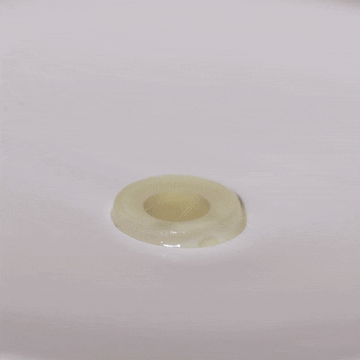 A white ring from Odacité Edelweiss Extrême Skin Barrier Set dissolves and fizzes in clear water.