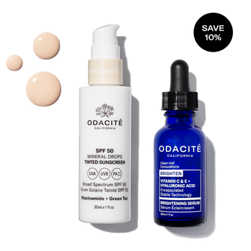 Odacité Sun Damage Defense Duo SPF 50 and Vitamin C bottles on a white background with visible lotion drops.
