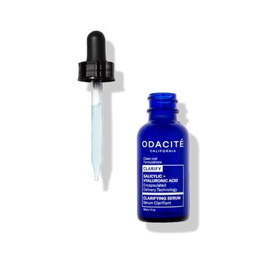 Odacité Clarifying Serum Salicylic + Hyaluronic Acid with glass dropper and light blue liquid on a white background.