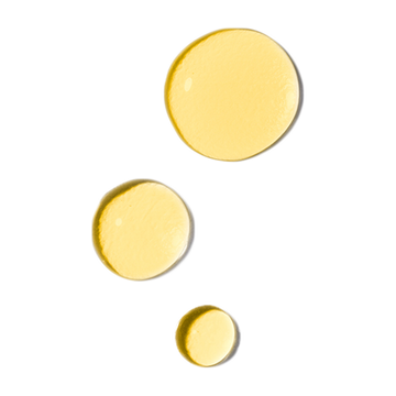 Three yellow drops of Odacite All-Embracing Watermelon + Hibiscus Facial Oil arranged diagonally on a white background.