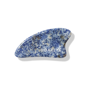The Odacite Gua Sha Facial Massage Set with marbled blue and white stone tools on a plain background.