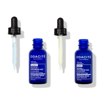 Two blue Odacité Let's Be Clear Power Duo serum bottles with droppers, labeled Salicylic Acid and Encapsulated Retinol.