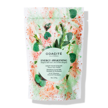 The Odacite Relax & Recenter Bath Set in a box with green leaves and bright orange and green accents on the packaging.