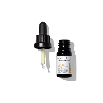 Odacité Brighten + Balance Uneven Skin Duo serum in a small bottle with dropper, yellow liquid inside, on a white background.
